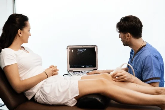 Ultraschalluntersuchung an dem Bein einer Frau - AMT Abken